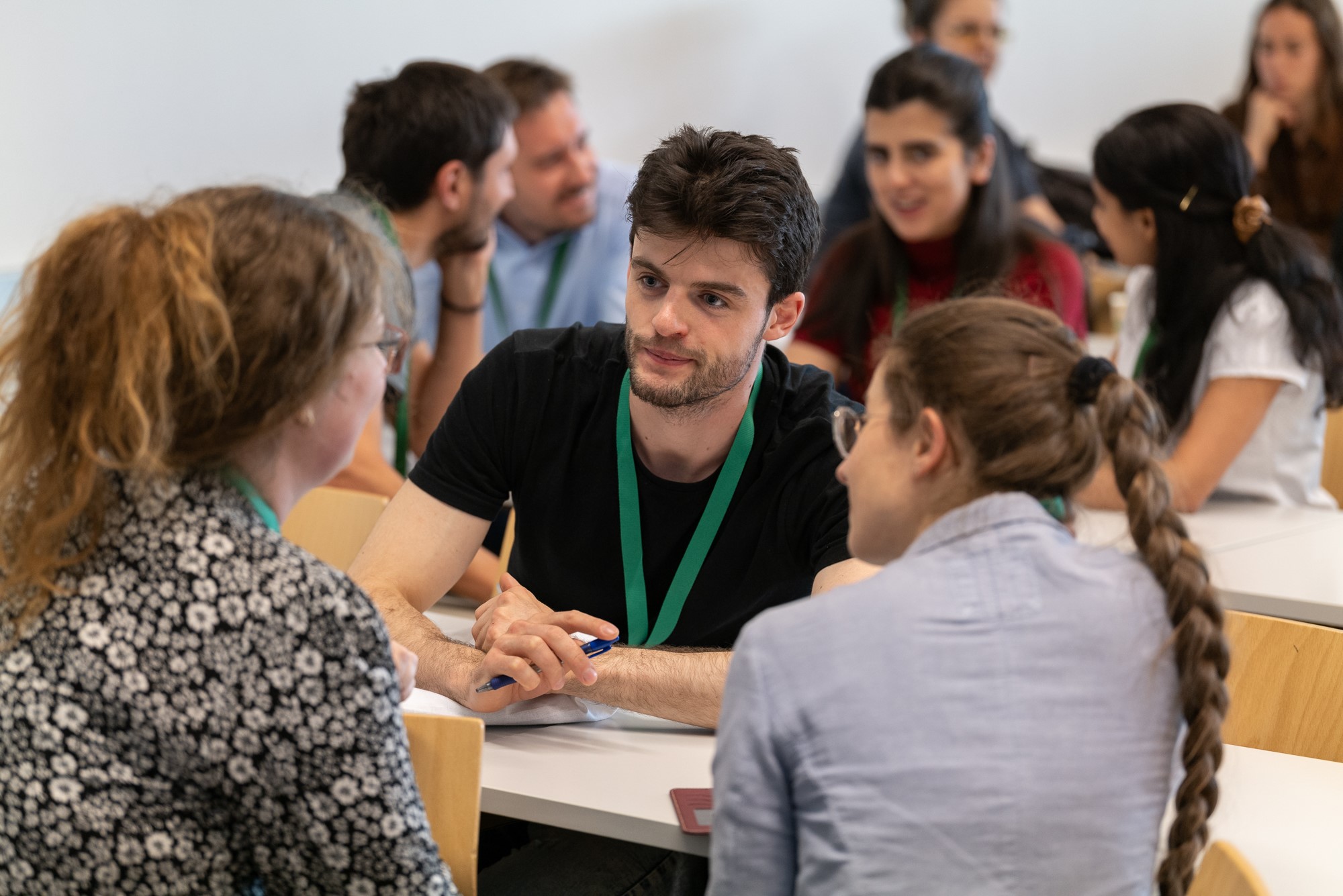 Studierende im Gespräch an einem Messestand